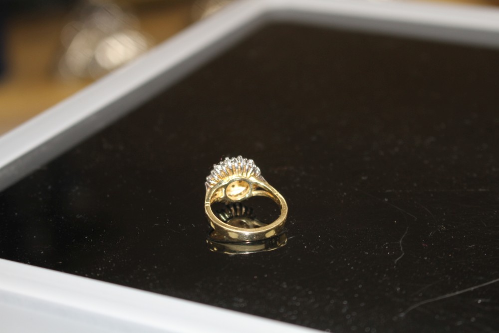 A modern 18ct gold and diamond cluster ring, size M, gross weight 7.8 grams.
